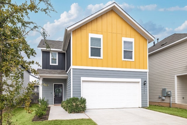 traditional-style home featuring an attached garage, roof with shingles, board and batten siding, and concrete driveway