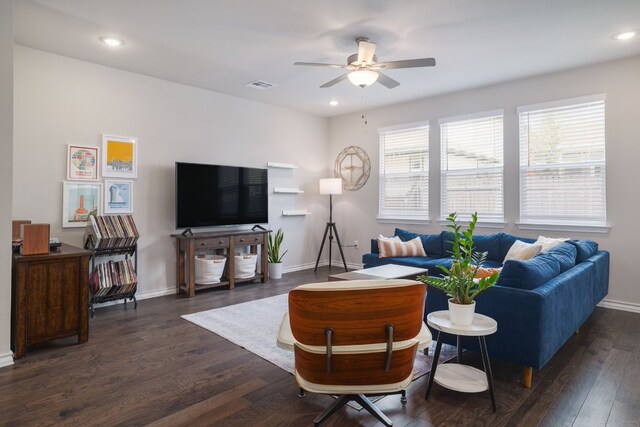 living area featuring a ceiling fan, baseboards, dark wood-type flooring, and recessed lighting