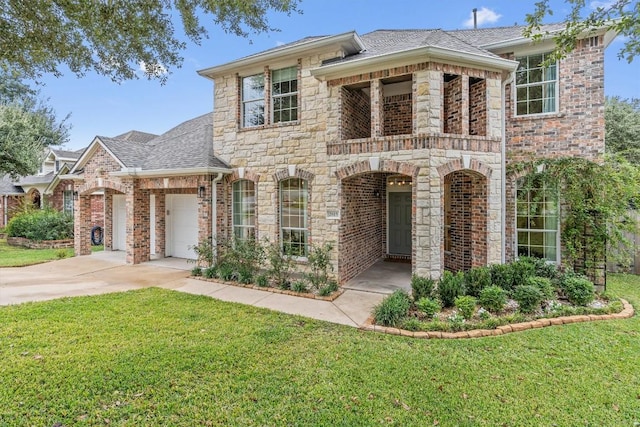 view of front of home with an attached garage, a shingled roof, driveway, stone siding, and a front yard