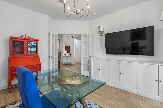 dining room featuring visible vents, a chandelier, wood finished floors, and french doors