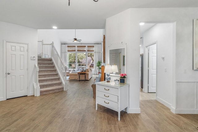 kitchen with a ceiling fan, baseboards, white cabinets, light countertops, and light wood finished floors