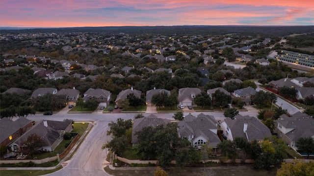 aerial view at dusk featuring a residential view