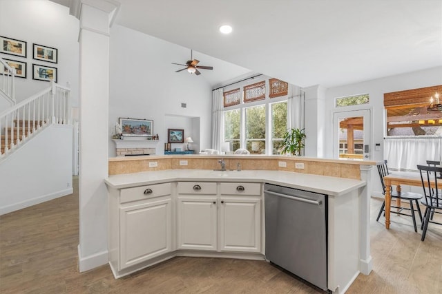 kitchen with a ceiling fan, light wood-style floors, white cabinetry, light countertops, and dishwasher