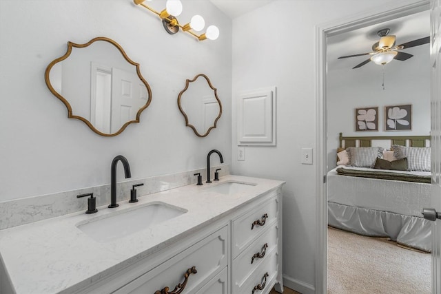 bathroom featuring ceiling fan, a sink, and double vanity