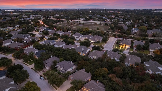 aerial view at dusk featuring a residential view