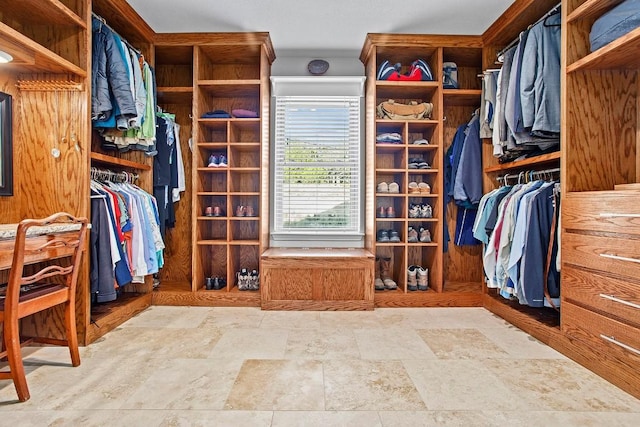 spacious closet with stone finish floor