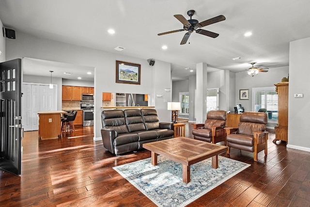 living area with recessed lighting, visible vents, dark wood finished floors, and baseboards