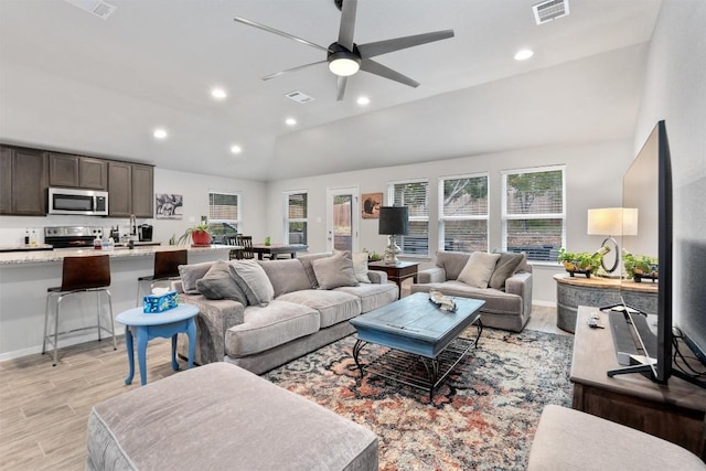 20602 Falcon, Lago Vista, TX 78645 - living room featuring vaulted ceiling, recessed lighting, ceiling fan, and light wood-type flooring