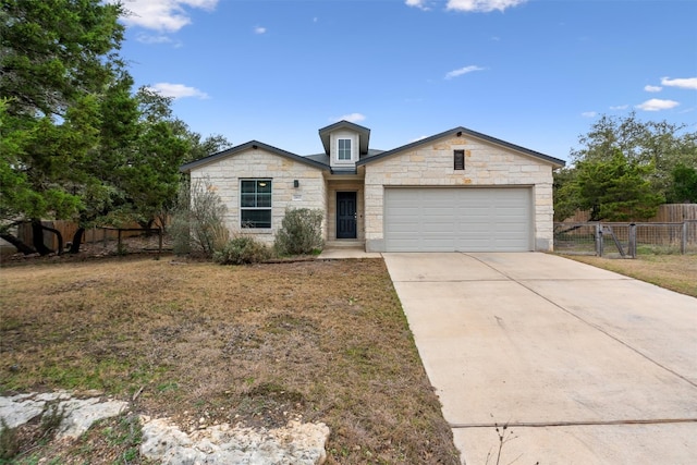 view of front of home featuring a garage, a front yard, concrete driveway, and fence