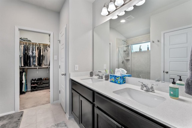 20602 Falcon, Lago Vista, TX 78645 - full bathroom featuring double vanity, a shower stall, a spacious closet, and tile patterned floors