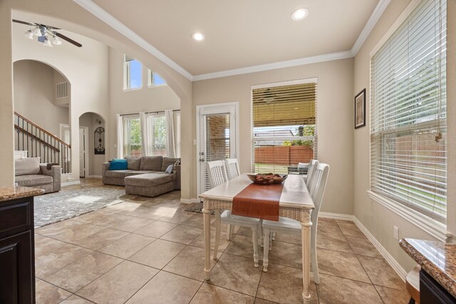 dining area with visible vents, baseboards, arched walkways, stairs, and crown molding