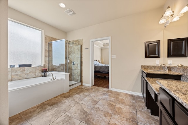 bathroom with a garden tub, a stall shower, ensuite bathroom, baseboards, and vanity