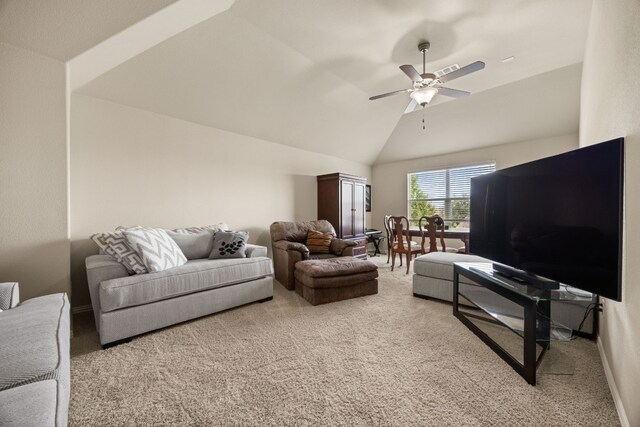 living area featuring carpet flooring, baseboards, lofted ceiling, and ceiling fan