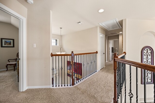 hallway with visible vents, attic access, an upstairs landing, carpet flooring, and recessed lighting