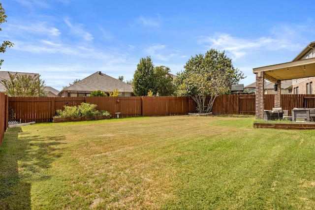 view of yard featuring a vegetable garden and a fenced backyard