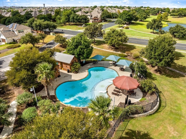 pool featuring a patio, fence, and a residential view