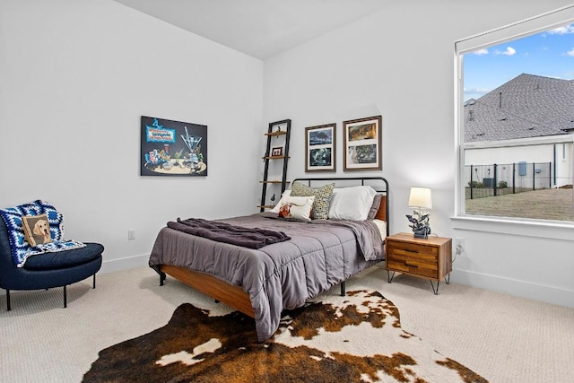 carpeted bedroom featuring baseboards