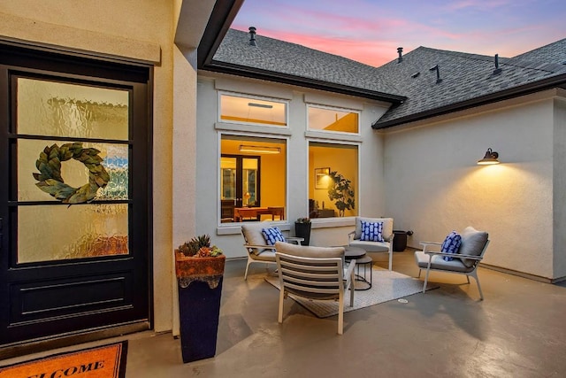 view of patio terrace at dusk