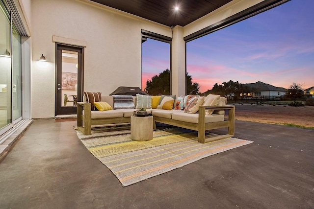 patio terrace at dusk with an outdoor living space