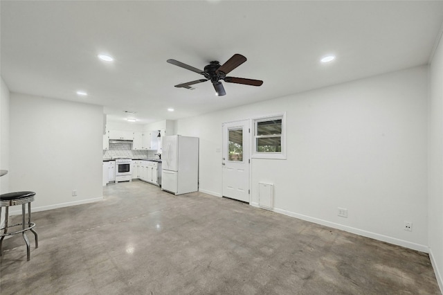 unfurnished living room featuring concrete flooring, recessed lighting, and baseboards