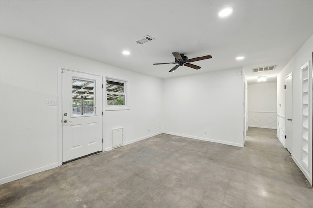 spare room featuring recessed lighting, visible vents, and concrete floors