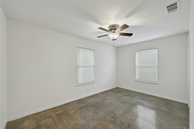 spare room featuring baseboards, visible vents, and a ceiling fan