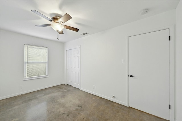 unfurnished bedroom with baseboards, visible vents, ceiling fan, and a closet