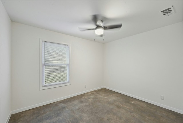 empty room featuring ceiling fan, visible vents, and baseboards