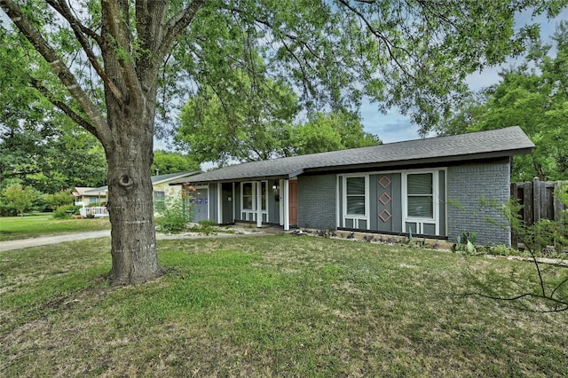 view of front of property with a front yard and brick siding