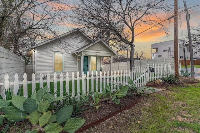 bungalow-style home with a fenced front yard and a gate