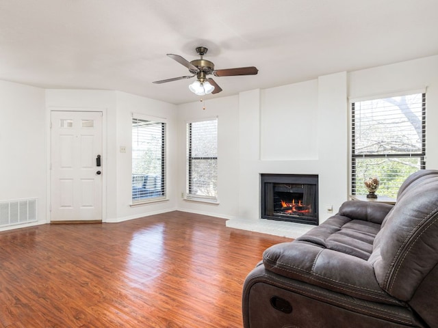 living area featuring plenty of natural light, wood finished floors, and visible vents