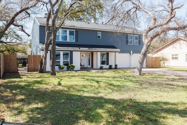 view of front facade with a garage, concrete driveway, fence, a porch, and a front yard