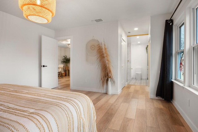 bedroom with light wood-type flooring, visible vents, baseboards, and recessed lighting