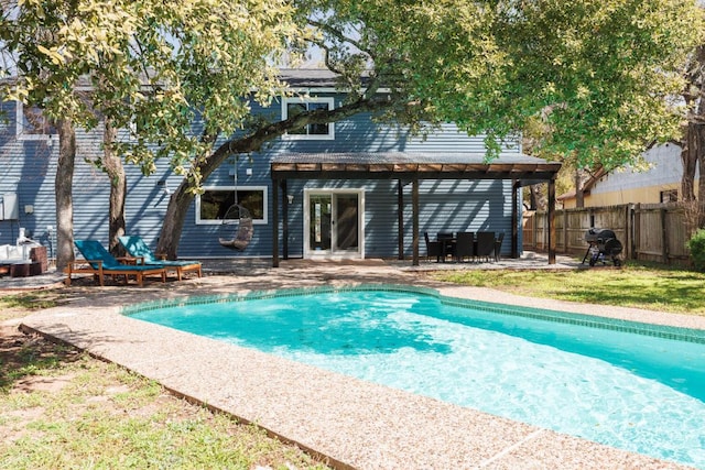 view of swimming pool featuring a fenced in pool, fence, and a patio