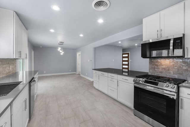 kitchen featuring baseboards, appliances with stainless steel finishes, visible vents, and white cabinets