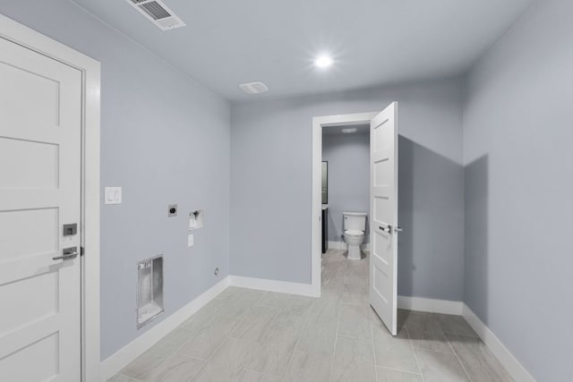 laundry area with laundry area, visible vents, electric dryer hookup, and baseboards