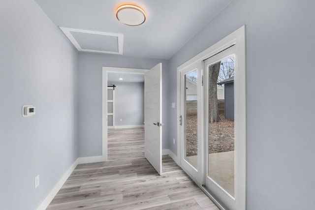 interior space featuring light wood-style flooring and baseboards