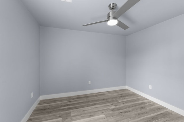 empty room featuring ceiling fan, baseboards, and wood finished floors