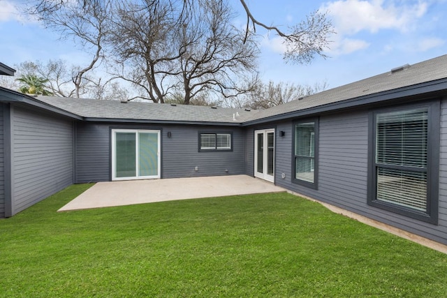 back of house featuring a lawn and a patio area