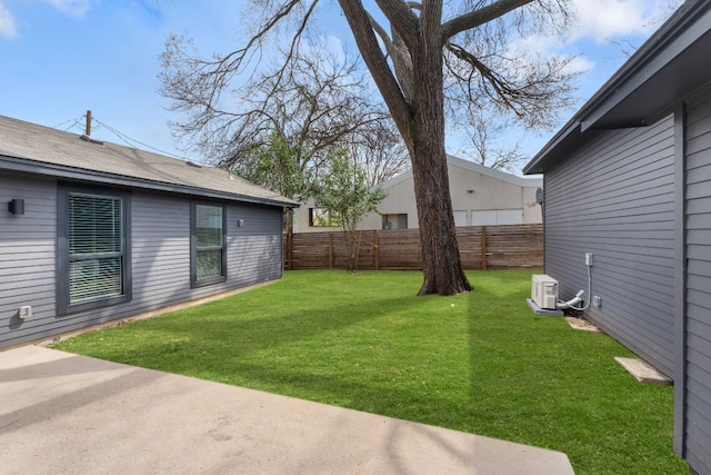 view of yard featuring fence private yard and ac unit