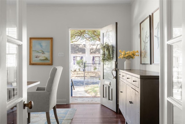 doorway to outside with a healthy amount of sunlight, ornamental molding, and dark wood finished floors