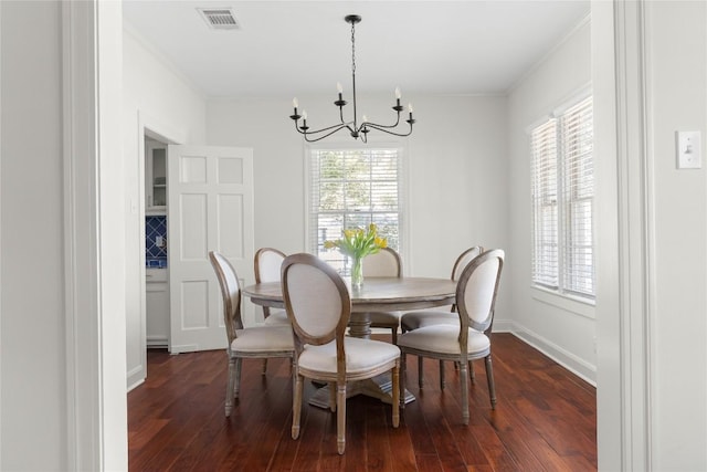 dining area with visible vents, dark wood-style flooring, and a wealth of natural light