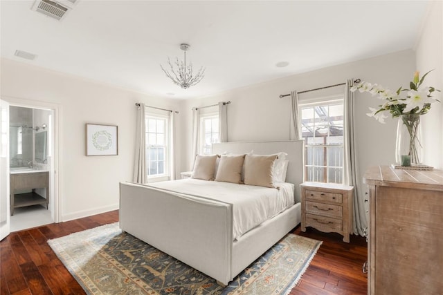 bedroom featuring baseboards, multiple windows, visible vents, and dark wood finished floors