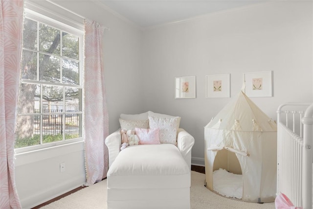 carpeted bedroom featuring baseboards and crown molding