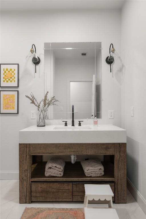 bathroom with visible vents, baseboards, and vanity