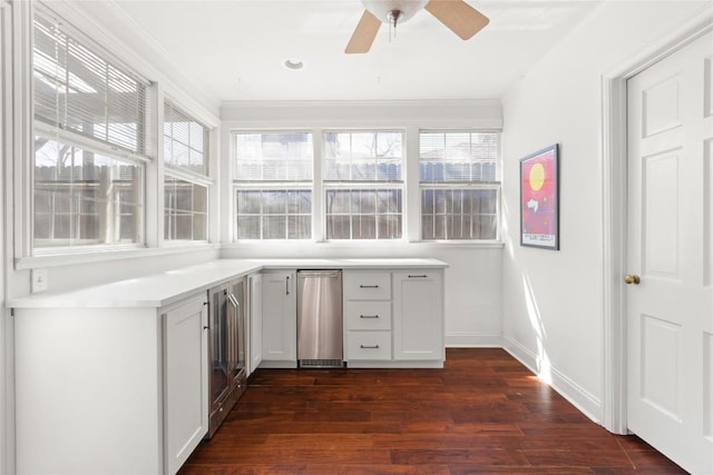 interior space with a ceiling fan, crown molding, dark wood finished floors, and baseboards