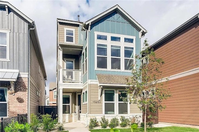 view of front of home featuring board and batten siding and a balcony