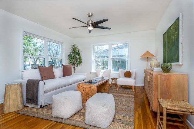 living room with baseboards, a ceiling fan, and wood finished floors