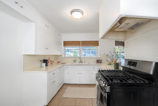 kitchen featuring light tile patterned floors, light countertops, a sink, gas range, and dishwasher