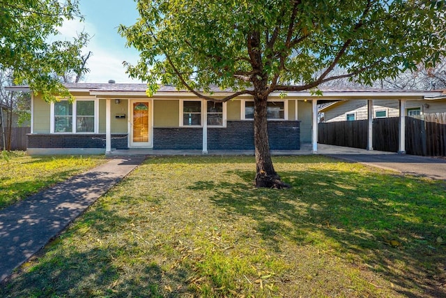 ranch-style home with stone siding, a front lawn, fence, and brick siding